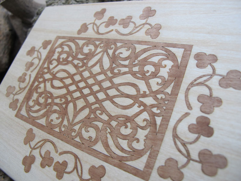 Laser cut and etched Wallnut veneer inlaid into birch wood