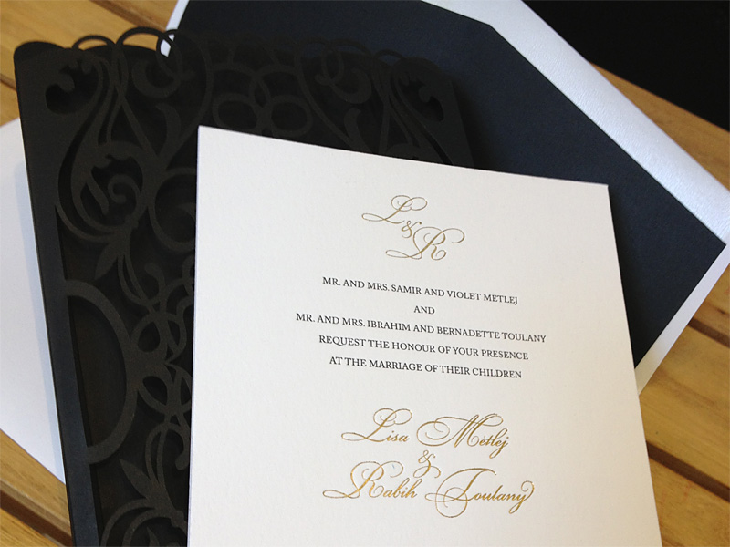 Custom chantilli lace laser cut invitation gold foil and letterpress showing invitation.