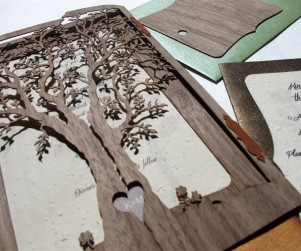 Walnut wood laser cut 'Love Tree' wedding invites featuring heart cutout