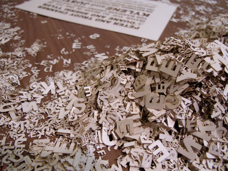 Laser cut outs of letters from wedding invitations