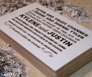 Stack of Fontography design laser cut wedding invitations