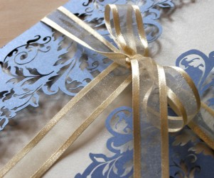 detail of Periwinkle Blue French Flair laser cut wedding invitations