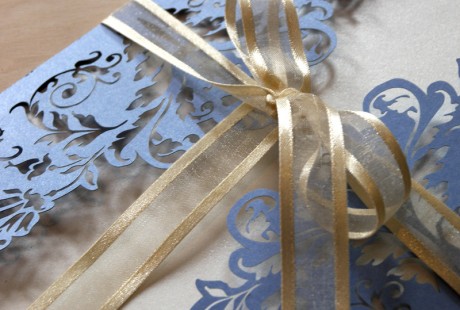 detail of Periwinkle Blue French Flair laser cut wedding invitations