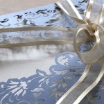 Close up on ribbon of French Flair laser cut wedding invitation