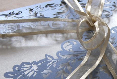 Close up on ribbon of French Flair laser cut wedding invitation