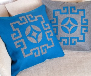 Laser cut throw pillows in blue and gray