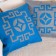Laser cut throw pillows in blue and gray