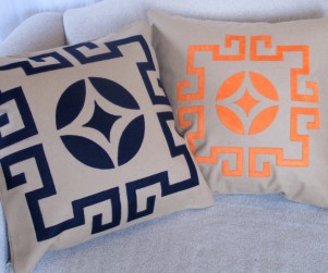 Laser cut throw pillows in navy blue and orange