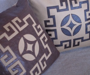 Laser cut throw pillows in camel and brown
